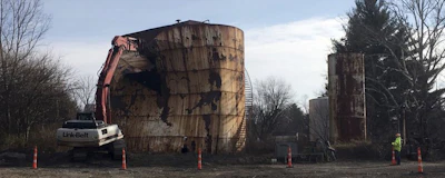 In this Dec. 11, 2017, photo, a tank at a Kiel Bros. facility is torn down in Indianapolis. The collapse of Kiel Bros. Oil Co. in 2004 was widely publicized. Less known is that the state of Indiana and, to a smaller extent, Kentucky and Illinois, are still on the hook for millions of dollars to clean up more than 85 contaminated sites across the three states, including underground tanks that leaked toxic chemicals into soil, streams and wells. (AP Photo/Brian Slodysko)
