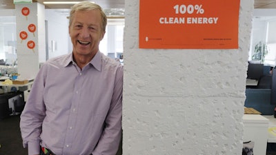 In this photo taken Wednesday, June 27, 2018, environmental activist & billionaire Tom Steyer poses at his offices in San Francisco. Arizona’s largest utility is fiercely opposing a push to mandate increased use of renewable energy in the sun-drenched state, setting up a political fight over the measure funded by Steyer. (AP Photo/Eric Risberg)
