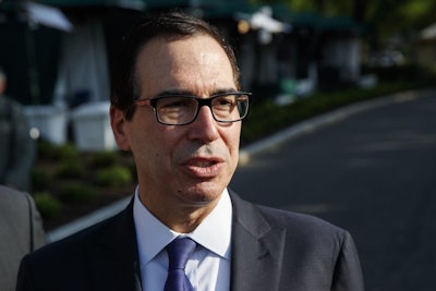 In this May 21, 2018, file photo, Treasury Secretary Steve Mnuchin talks with reporters about trade with China outside of the White House in Washington. Countries and businesses that continue to import Iranian oil could avoid penalties by making “significant reductions” as Washington re-imposes sanctions on Tehran later this year, according to top U.S. officials. “We want people to reduce oil purchases to zero, but in certain cases if people can’t do that overnight, we’ll consider exemptions,” Mnuchin told journalists as he and Secretary of State Mike Pompeo returned to the U.S. from Mexico late last week. (AP Photo/Evan Vucci)