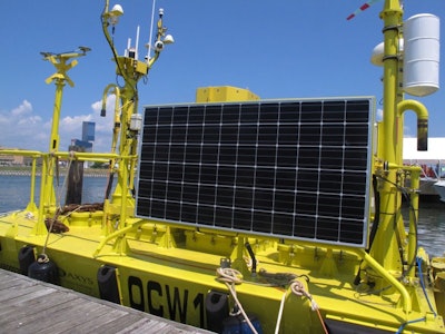 This photo shows a research buoy in Atlantic City, N.J., July 16, 2018, before it was to be positioned 10 miles off the coast as part of preparations for an offshore wind turbine field to generate electricity. (AP Photo/Wayne Parry)