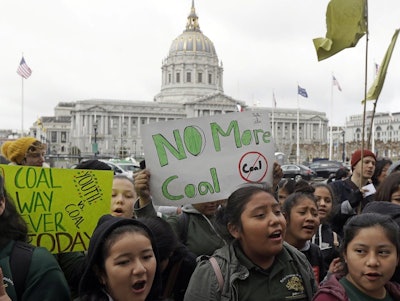In this Feb. 28, 2018, file photo, students rally for clean energy in front of San Francisco City Hall. A U.S. judge who held a hearing about climate change that received widespread attention has thrown out the underlying lawsuits that sought to hold big oil companies liable for the role of fossil fuels in the Earth's warming environment. Judge William Alsup in San Francisco said Monday, June 25, 2018, that Congress and the president, not a federal judge, were best suited to address fossil fuels' contribution to global warming. (AP Photo/Jeff Chiu)