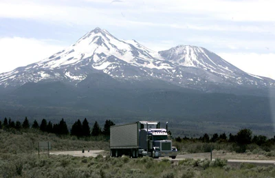 In this June 19, 2008, file photo a truck drives past Mount Shasta near Weed, Calif. California and 14 other states are suing the Trump administration over its decision to suspend an Obama-era rule aimed at limiting pollution from trucks. The lawsuit filed Thursday, July 19, 2018, in the U.S. Court of Appeals for the District of Columbia Circuit says the July 6 decision by the Environmental Protection Agency was illegal and could put thousands of additional highly polluting trucks on the roads. (AP Photo/Rich Pedroncelli)