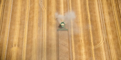 FILE - In this June 27, 2018 a harvester cuts crop in Schönefeld near Berlin. Germany’s farmers expect a poor harvest this year due to a prolonged drought and an unusually long stretch of warm weather. (Ralf Hirschberger/dpa via AP)