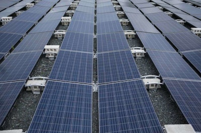 In this July 20 photo, solar panels installed by Tesla, power a community of 12 homes in the mountain town of Las Piedras, Puerto Rico. The homes still do not have power from the national grid, more than 10 months after Hurricane Maria and now is operating exclusively on solar energy. (AP Photo/ Dennis M. Rivera Pichardo)