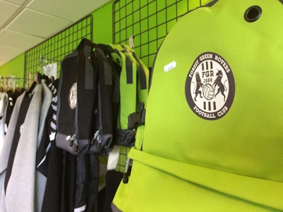 In this Monday, July 30, 2018 photo, goods for sale at The New Lawn, Forest Green Rovers’ football ground, in Nailsworth, England. An English soccer club has become the first professional sports team in the world to be certified as carbon neutral by the United Nations. (AP Photo/James Brooks)