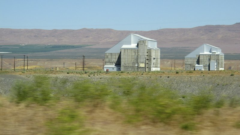 This June 13, 2017 file photo shows two decommissioned plutonium-producing reactors on the Hanford Nuclear Reservation near Richland, Wash. The land where the federal government created some of the plutonium for nuclear weapons will be so cleaned of radiation and other pollution that it could be used for homes in the future. The plan announced Monday, July 30, 2018, would spend $200 million to clean up 7.8 square miles in a portion of Hanford called the 100 Area D and H areas. (AP Photo/Nicholas K. Geranios)