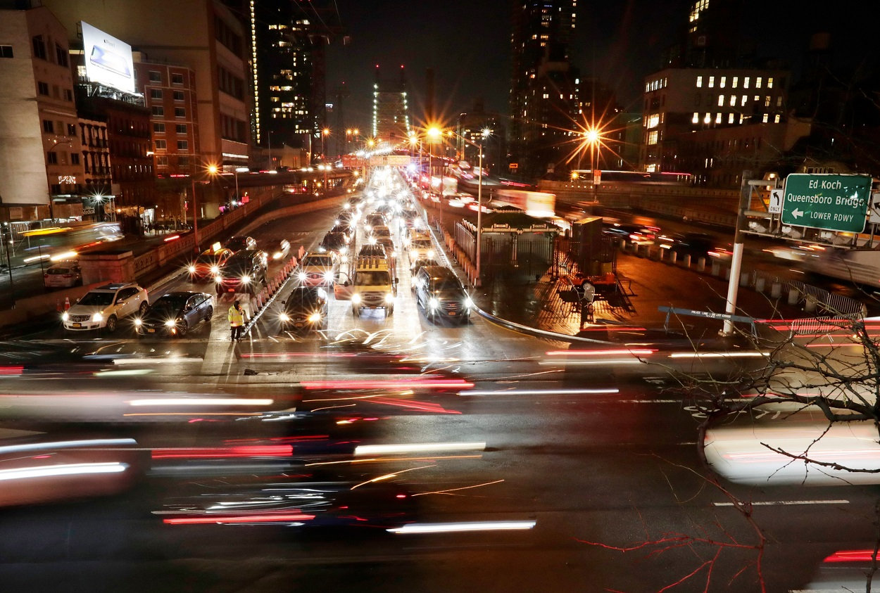 In this Jan. 11, 2018, file photo, cars pass the Queensboro Bridge in New York. The Trump administration is citing safety to justify freezing gas mileage requirements. Image credit: AP Photo/Frank Franklin II, File