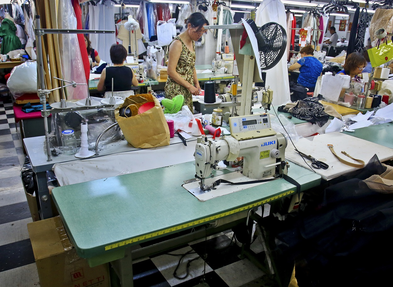 In this Aug. 1, 2018 photo, a sewing station sits as garment workers assemble clothing at Absolute Couture, one of the few remaining garment manufacturers in New York's Garment District. Image credit: AP Photo/Bebeto Matthews