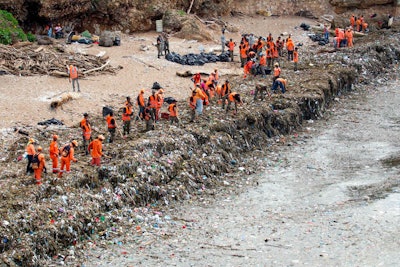 Workers collecting garbage from a beach in Santo Domingo, the capital of the Dominican Republic, this month. (Erika Santelices/Agence France-Presse via Getty Images)
