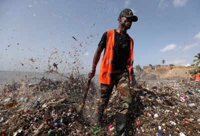 Hundreds of city workers and volunteers have been waging an uphill battle against wave after wave of sludgy garbage. (Ricardo Rojas/Reuters)