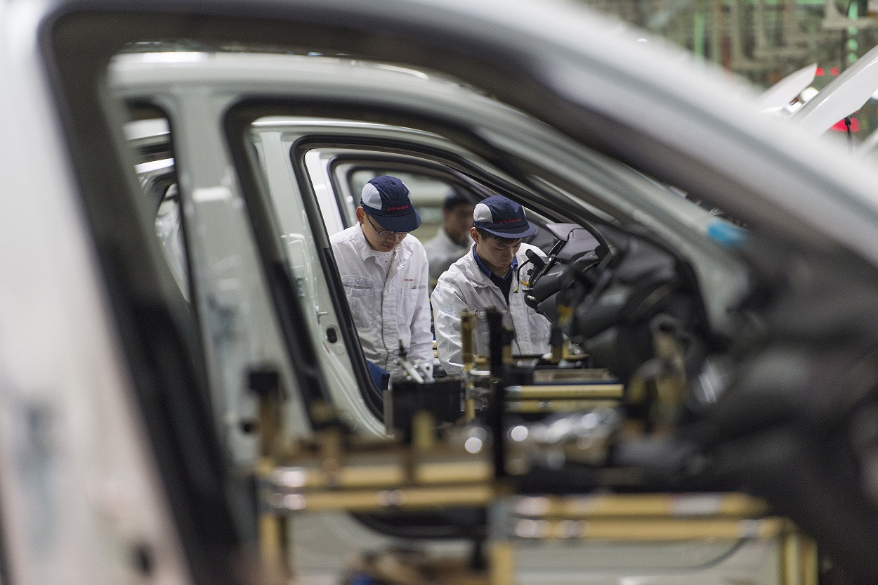 In this Feb. 6, 2017, photo, workers assemble cars at the Dongfeng Honda automotive plant in Wuhan in central China's Hubei province. Image credit: Chinatopix via AP