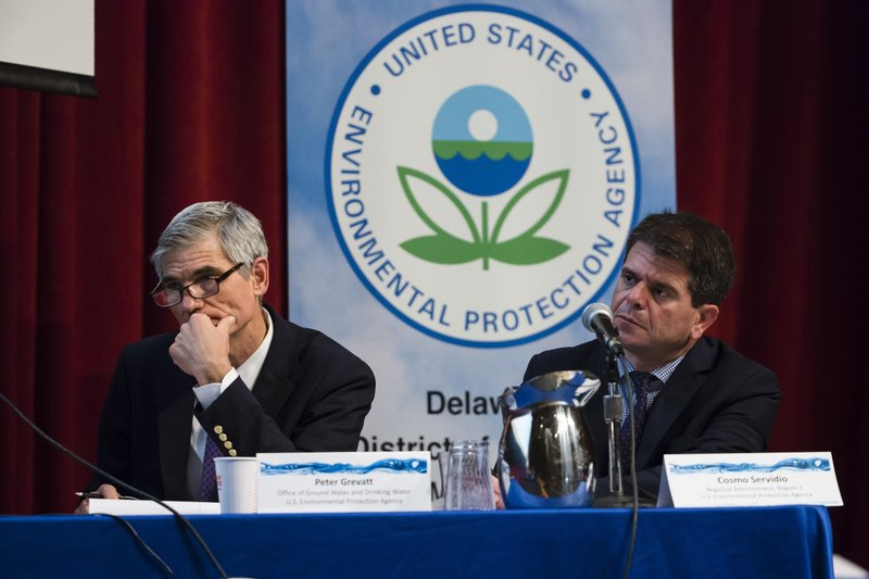 In this July 25, 2018 photo U.S. Environmental Protection Agency's Peter Grevatt, Director of the Office of Ground Water and Drinking Water and Cosmo Servidio, Regional Administrator for the Mid-Atlantic Region, listen to members of the public comment during a PFAS Community Stakeholder Meeting, on in Horsham, Pa. In Horsham and surrounding towns in eastern Pennsylvania, and at other sites around the United States, the foams once used routinely in firefighting training at military bases contained per-and polyfluoroalkyl substances, or PFAS. EPA testing between 2013 and 2015 found significant amounts of PFAS in public water supplies in 33 U.S. states. (AP Photo/Matt Rourke)