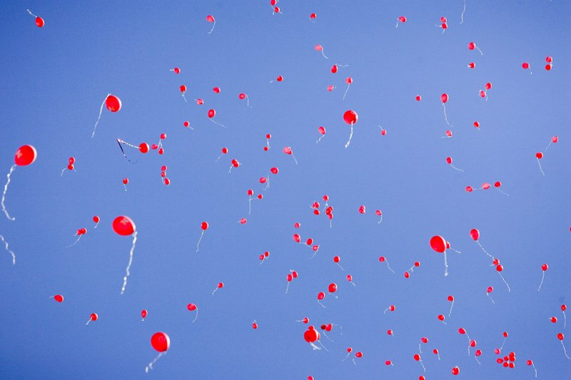 In this Sept. 11, 2010, file photo red balloons fill the sky after Nebraska scored its first touchdown against Idaho in their NCAA college football game in Lincoln, Neb. The celebration of releasing balloons into the air has long bothered environmentalists, who say the pieces that fall back to earth can be deadly to seabirds and turtles that eat them. So as companies vow to banish plastic straws, there are signs balloons are among the products getting more scrutiny. (AP Photo/Nati Harnik)