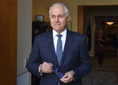 Australia's Prime Minister Malcolm Turnbull arrives for a meeting with Poland's President Andrzej Duda at Parliament House in Canberra, Monday, Aug. 20, 2018. Turnbull abandoned plans to legislate to limit greenhouse gas emissions to head off a revolt by conservative lawmakers. (Mick Tsikas/Pool Photo via AP)