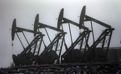 In this Dec. 19, 2014, file photo, oil pump jacks work in unison in Williston, N.D. Image credit: AP Photo/Eric Gay, File