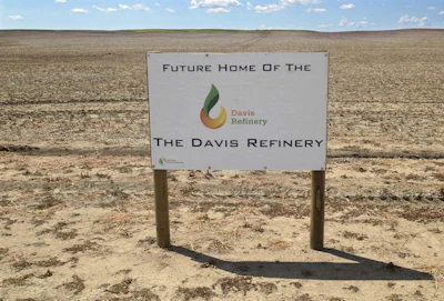This July 19, 2018, file photo, shows a sign on property, near southwest Belfield, N.D, for the future home of the Davis Refinery near Theodore Roosevelt National Park. Opponents of an oil refinery planned near Theodore Roosevelt National Park in North Dakota are imploring state regulators to give them a chance to explore whether the developer is being truthful about the project's size. Meridian Energy Group maintains it doesn't need a state siting permit because the $800 million Davis Refinery won't have a big enough capacity. (Tom Stromme/The Bismarck Tribune via AP)