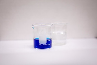 A beaker containing a methylene blue solution. (Meredith Forrest Kulwicki/University at Buffalo)