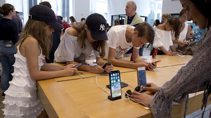 In this Aug. 2, 2018, file photo customers browse in an Apple store in New York. Image credit: AP Photo/Mark Lennihan, File