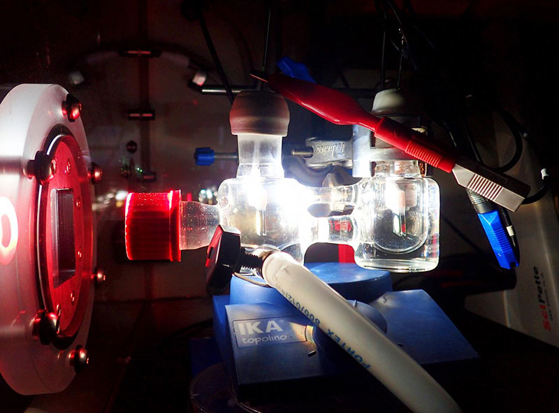 Experimental two-electrode setup showing the photoelectrochemical cell illuminated with simulated solar light. (Katarzyna Sokó)