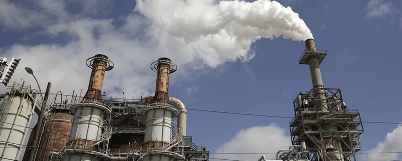In this March 29, 2018, photo, steam is released out of the Valero Refinery in Houston. More than a year after Hurricane Harvey slammed into the Texas coast, state environmental authorities have only just begun enforcement actions against a handful of companies deemed responsible for some of the most massive air and water pollution incidents reported during and immediately after the storm. (Elizabeth Conley/Houston Chronicle via AP)