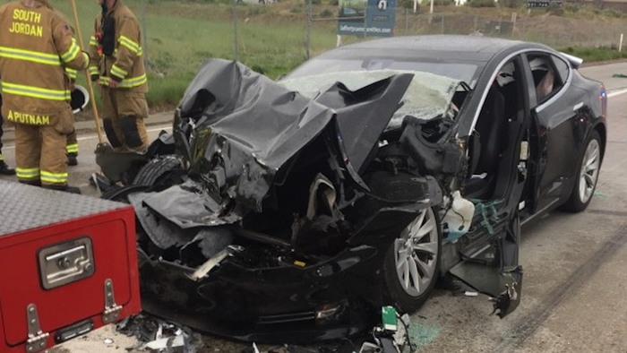In this May 11, 2018, file photo, released by the South Jordan Police Department shows a traffic collision involving a Tesla Model S sedan with a fire department mechanic truck stopped at a red light in South Jordan, Utah. Image credit: South Jordan Police Department via AP, File