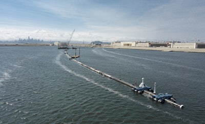 In this Monday, Aug. 27, 2018 photo provided by The Ocean Cleanup, a long floating boom that will be used to corral plastic litter in the Pacific Ocean is assembled in Alameda, Calif. Image credit: The Ocean Cleanup via AP