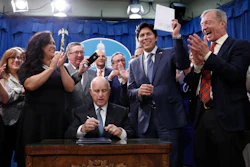State Sen. Kevin de Leon, D-Los Angeles, right, shakes hands with Gov. Jerry Brown after Brown signed his environmental measure SB100, Monday, Sept. 10, 2018, in Sacramento, Calif. Image credit: AP Photo/Rich Pedroncelli