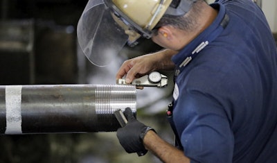 In this June 5, 2018, file photo Erik Cordova inspects a steel pipe at the Borusan Mannesmann Pipe manufacturing facility Tuesday, June 5, 2018, in Baytown, Texas. Image credit: AP Photo/David J. Phillip, File