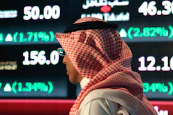 In this June 15, 2015, file photo, a Saudi man walks through the Tadawul Saudi Stock Exchange in Riyadh, Saudi Arabia. Image credit: AP Photo/Hasan Jamali, File