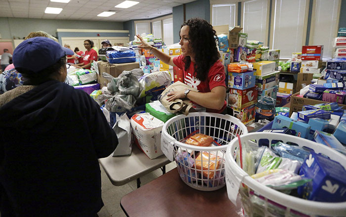 Volunteers at the Senior Center in Lawrence, Mass. hand out food and supplies, Tuesday, Sept. 18, 2018, in the wake of last week's gas explosions and house fires in the Merrimack Valley. (AP Photo/Elise Amendola)