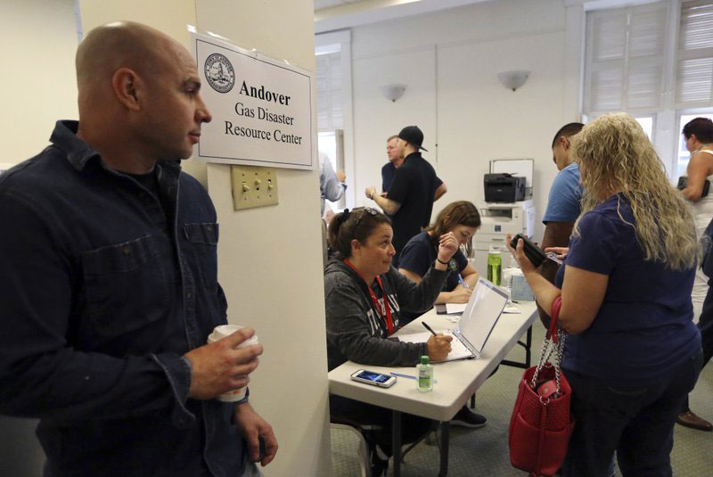 Residents wait for information and to file claims, Wednesday, Sept. 19, 2018, in Andover, Mass., in the wake of last week's gas explosions and fires. About 8,600 customers were affected by the explosions, with many having to evacuate their homes for days, and some possibly having to go without gas service for weeks. (AP Photo/Elise Amendola)
