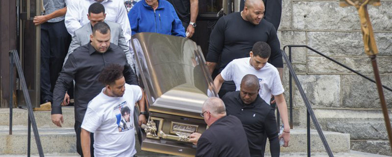 Miguel and Rosaly Rondon, parents of Leonel Rondon, 18, who died in the gas explosions in South Lawrence last week, watch as pall bearers carry their son's casket out of St. Mary the Assumption Parish in Lawrence, Mass., Wednesday, Sept. 19, 2018. (Amanda Sabga/The Eagle-Tribune via AP)