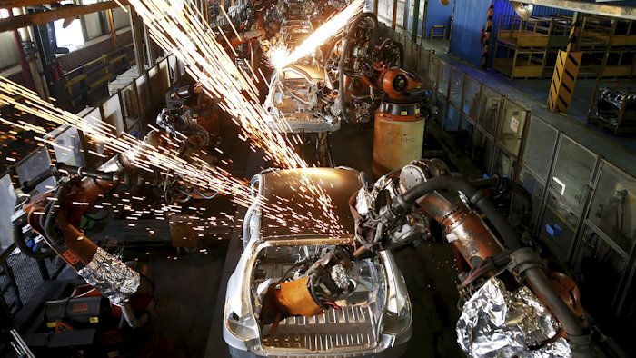 In this Sunday, Sept. 9, 2018 photo, bodies of cars gothrough an assembly line at the Iran Khodro automobile manufacturing plant, just outside Tehran, Iran. Image credit: AP Photo/Ebrahim Noroozi