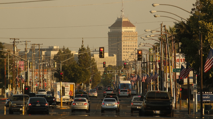In this June 23, 2017 file photo, cars and trucks roll along a section of Blackstone Avenue during rush hour in Fresno, Calif. Image credit: AP Photo/Gary Kazanjian, File