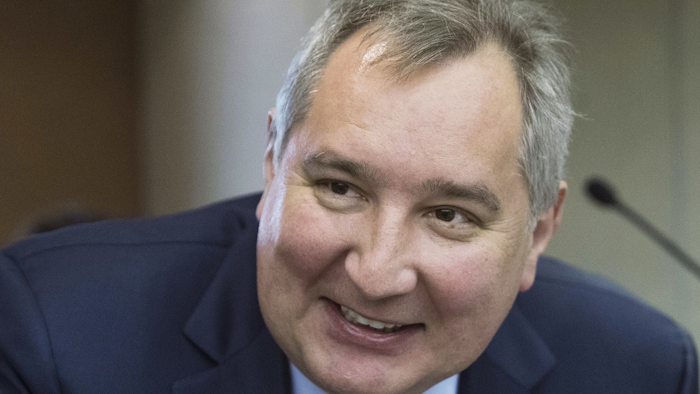In this file photo taken on Wednesday, April 11, 2018, Russian Deputy Prime Minister Dmitry Rogozin smiles before Russian Prime Minister Dmitry Medvedev's annual report on country's economic and social development in the State Duma, the Lower House of the Russian Parliament, in Moscow, Russia. Image credit: AP Photo/Pavel Golovkin, File