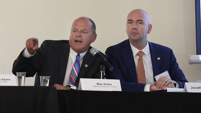 Mike Stoker, regional administrator of the US EPA, directs speakers as Jonathan Morrison of NHTSA looks on during the first of three public hearings on the Trump administration's proposal to roll back car-mileage standards in a region with some of the nation's worst air pollution Monday, Sept. 24, 2018 in Fresno, Calif. Image credit: AP Photo/Gary Kazanjian