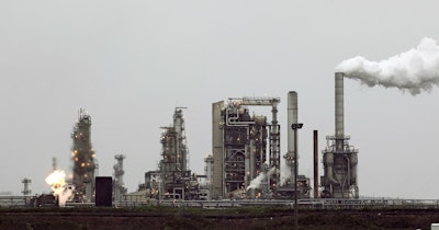 This April 2, 2010 file photo shows a refinery owned by Andeavor, formerly Tesoro Corp. including a gas flare flame that is part of normal plant operations, in Anacortes, Wash. Image credit: AP Photo/Ted S. Warren, File