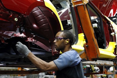 In this Sept. 27, 2018, file photo a line technician works on assembling a redesigned Nissan Altima sedan at its Nissan Canton Vehicle Assembly Plant in Canton, Miss. Image credit: AP Photo/Rogelio V. Solis, File