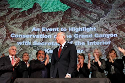 In this Jan. 9, 2012 file photo, then Interior Secretary Ken Salazar, center, standing in front of a map of the Grand Canyon, is applauded after announcing a twenty year ban on new mining claims near the Grand Canyon in Washington. Image credit: AP Photo/Jacquelyn Martin, File