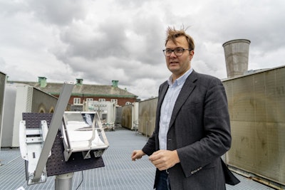 Professor Kasper Moth-Poulsen at the solar thermal collector, situated on the roof of the MC2 building at Chalmers University of Technology. (Johan Bodell/Chalmers University of Technology)