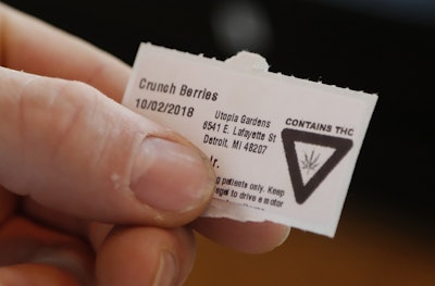 In this Tuesday, Oct. 2, 2018, photo, a warning label from Utopia Gardens, a medical marijuana dispensary, is shown in Detroit. Image credit: AP Photo/Carlos Osorio