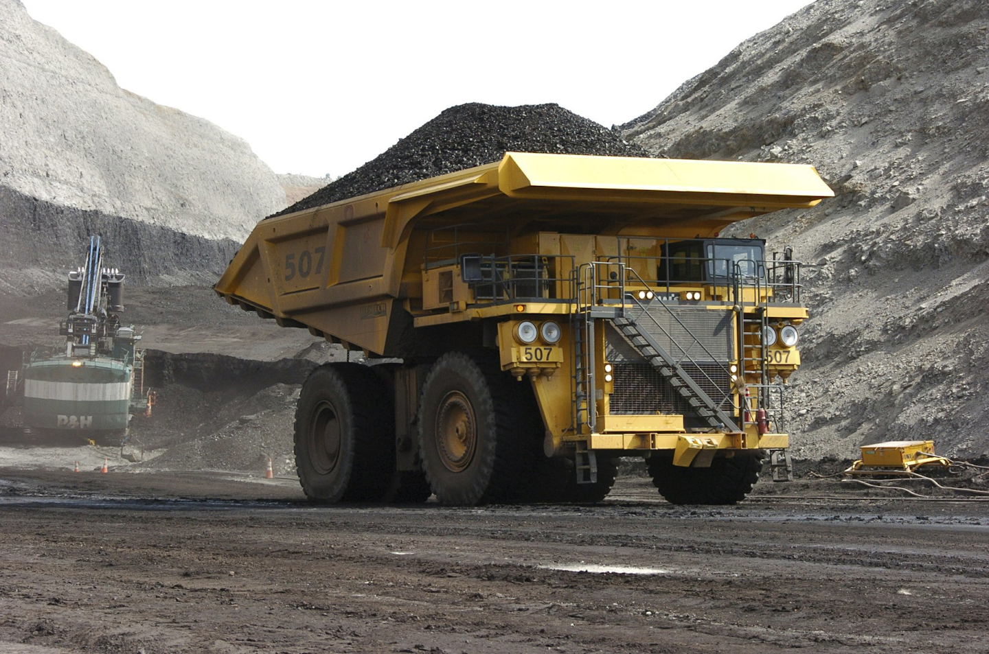 In this April 4, 2013, file photo, a mining dumper truck hails coal at Cloud Peak Energy's Spring Creek strip mine near Decker, Mont. The Trump administration is considering using West Coast military bases or other federal properties as transit points for shipment of U.S. coal and natural gas to Asia. (AP Photo/Matthew Brown)