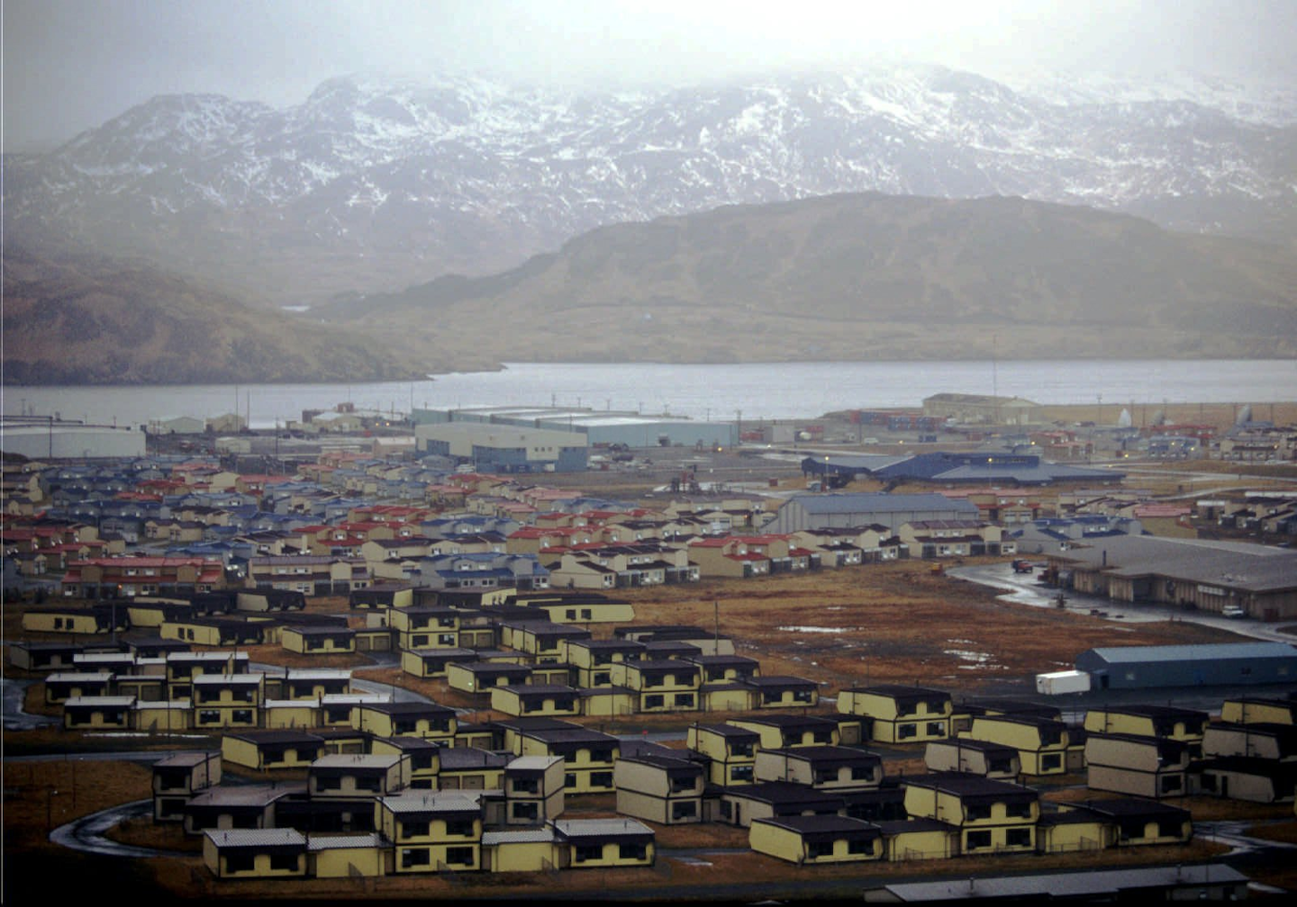 In this February 1997 file photo, hundreds of houses, which over 6,000 military personnel and dependents called home, along with schools, warehouses, hangars, and other structures sit empty on the Adak Naval Air Facility in Alaska. The Trump administration is considering using West Coast military bases or other federal properties as transit points for shipments of U.S. coal and natural gas to Asia. (AP Photo/Al Grillo)