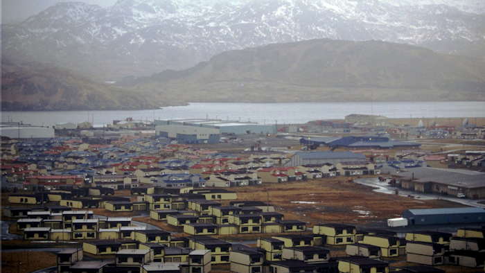 In this February 1997 file photo, hundreds of houses, which over 6,000 military personnel and dependents called home, along with schools, warehouses, hangars, and other structures sit empty on the Adak Naval Air Facility in Alaska. Image credit: AP Photo/Al Grillo, File