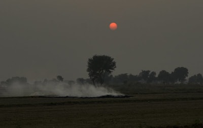 Smoke rises as farmers burn crop stubble during sunset at a village near Mathura, India, Saturday, Oct. 20, 2018. The Indian capital and large parts of north India gasp for breath for most of the year due to air pollution caused by dust, burning of crops, emissions from factories and the burning of coal and piles of garbage. (AP Photo/R S Iyer)
