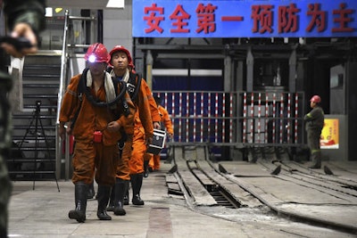 In this photo taken Oct. 21, 2018 and released by Xinhua News Agency, rescuers walk out of the site of a coal mine where falling rocks killed miners and trapped some in Yuncheng County in eastern China's Shandong Province. Image credit: Guo Xulei/Xinhua via AP