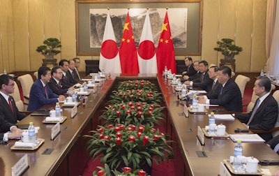 Japanese Prime Minister Shinzo Abe, second from left, talks with Chinese President Xi Jinping, second from right, during a meeting at the Diaoyutai State Guesthouse in Beijing Friday, Oct. 26, 2018. Image credit: Nicolas Asfouri/Pool photo via AP