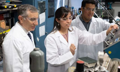 Rice University chemist James Tour, left, graduate student Gladys López-Silva and postdoctoral researcher Rodrigo Salvatierra use a film of carbon nanotubes to prevent dendrite growth in lithium metal batteries, which charge faster and hold more power than current lithium-ion batteries. (Jeff Filtow/Rice University)