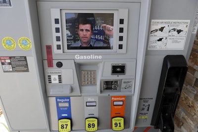 An ad supporting Proposition 6 plays on a screen on a pump at a gas station Wednesday, Oct. 24, 2018, in Santa Clarita, Calif. The ads are part of an advertising blitz by Proposition 6 supporters trying to drive home a message to voters to overcome what they see as a misleading title and summary on the ballot. The feud over messaging comes just weeks before an election where Californians will vote in a series of contentious races for Congress and state offices and ballot measures including the proposal to repeal an increase in gasolines taxes and vehicle fees slated to fund $5 billion in transportation projects a year. (AP Photo/Marcio Jose Sanchez)