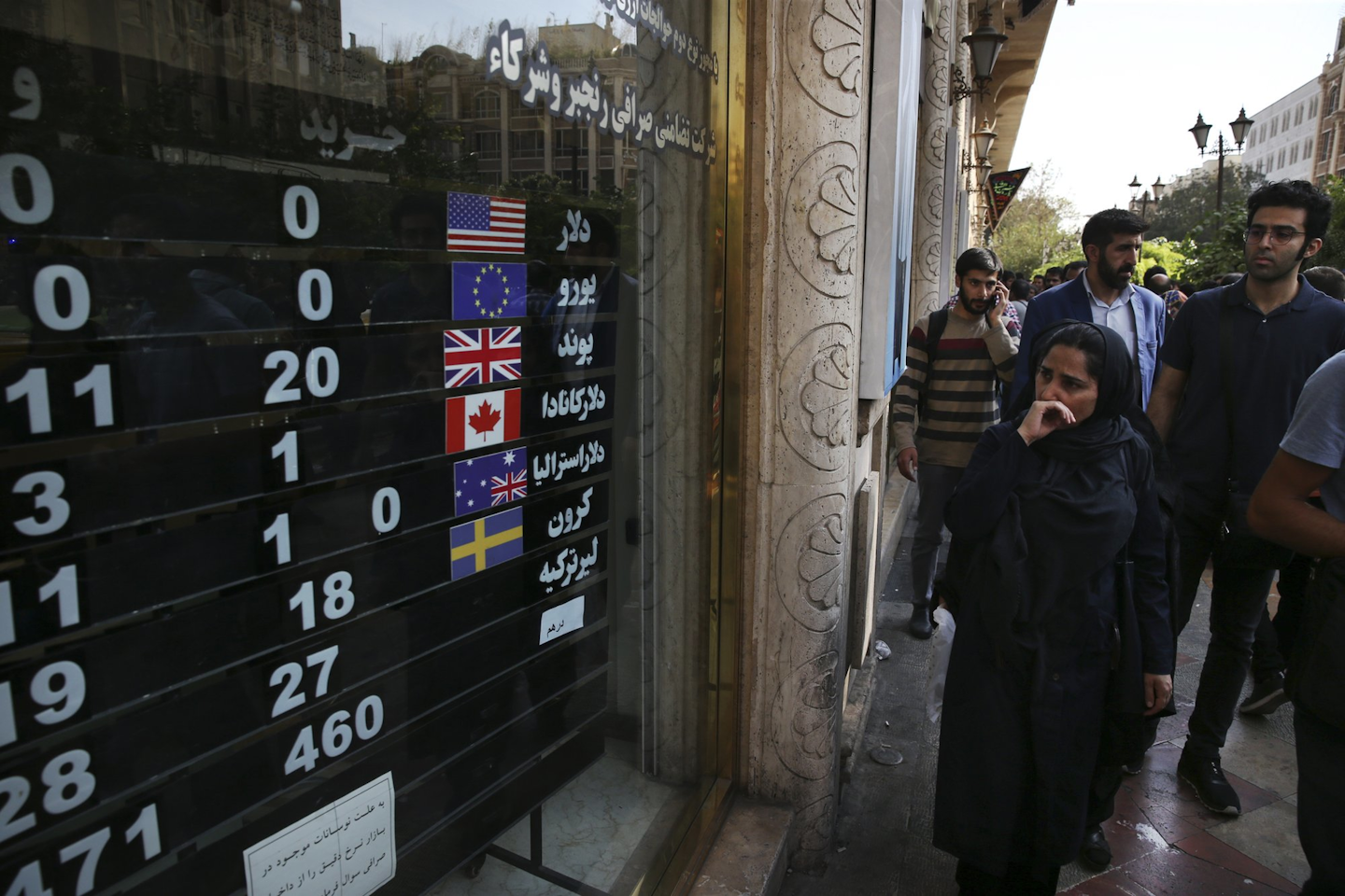 In this Oct. 2, 2018 file photo, an exchange shop displays rates for various currencies, in downtown Tehran, Iran. Iran is bracing for the restoration of U.S. sanctions on its vital oil industry set to take effect on Monday, Nov. 5, 2018, as it grapples with an economic crisis that has sparked sporadic protests over rising prices, corruption and unemployment. The oil sanctions will target the country’s largest source of revenue in the most punishing action taken since the Trump administration withdrew from the 2015 nuclear agreement in May. (AP Photo/Vahid Salemi)